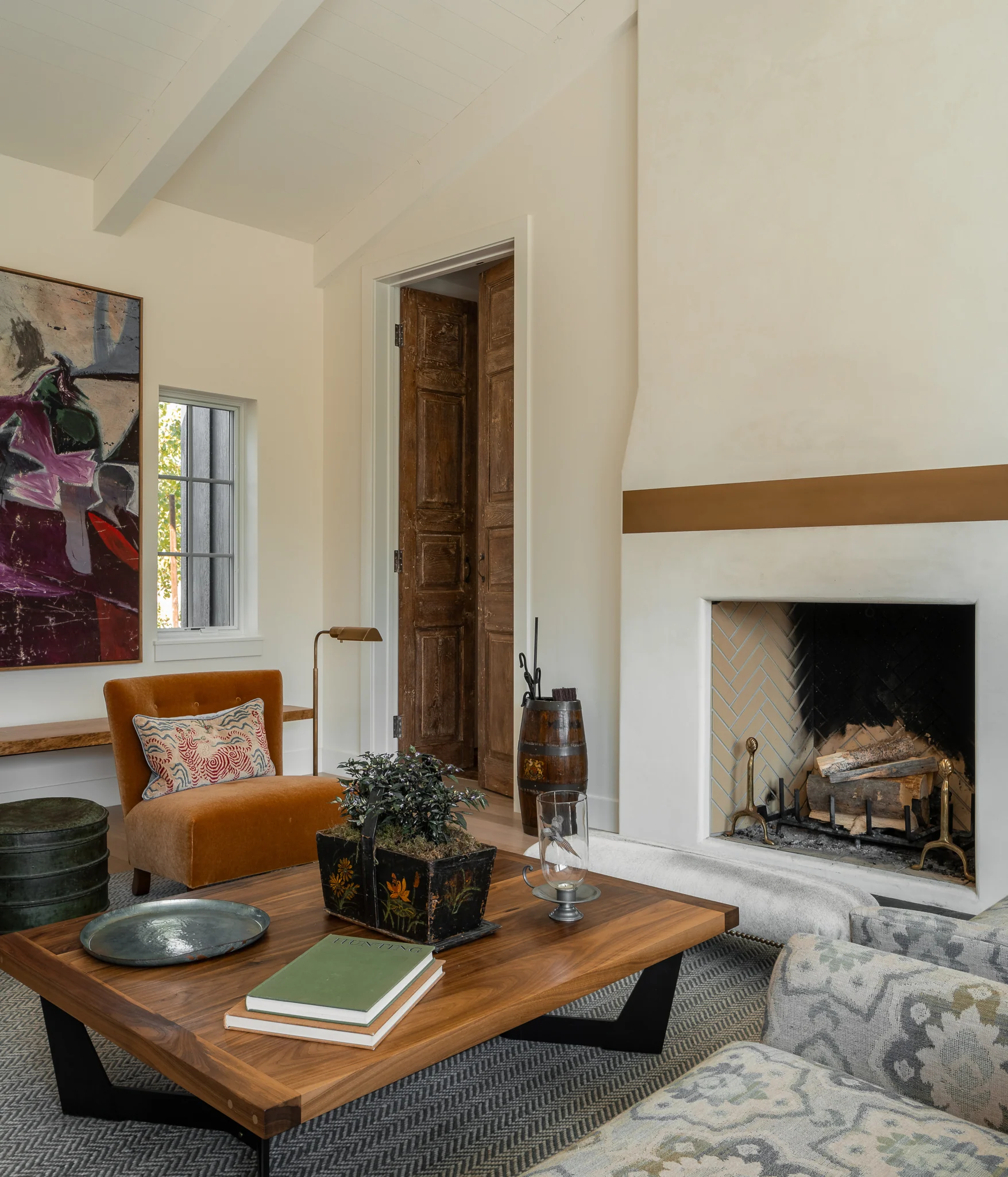 Living room fireplace with a leather chair and floral artwork — interior design photography Driggs Idaho, WTG Architects